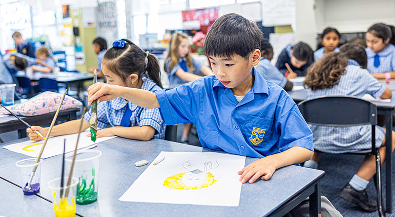 St Andrews Catholic Primary Marayong students painting in class