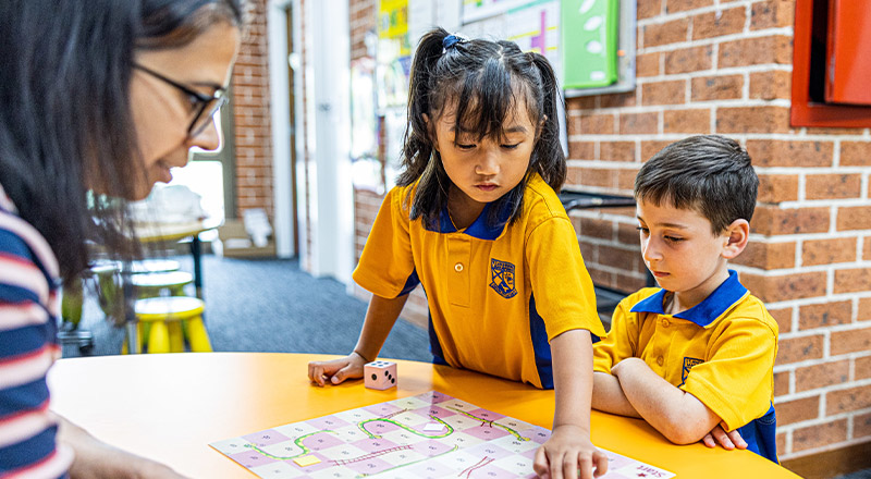Students learning with the teacher in the classroom at St Andrews Primary School Marayong