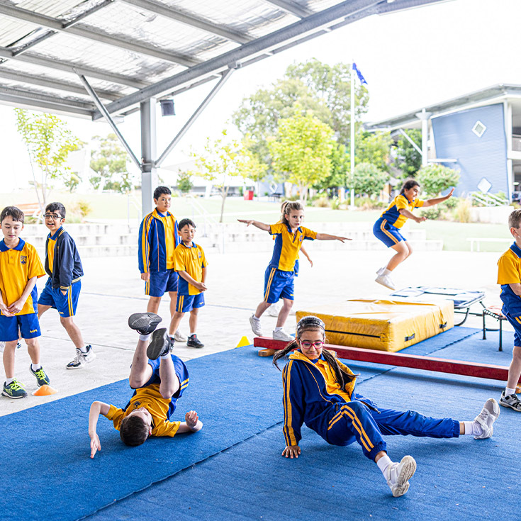 Students doing gymnastics outside at St Andrews Primary School Marayong