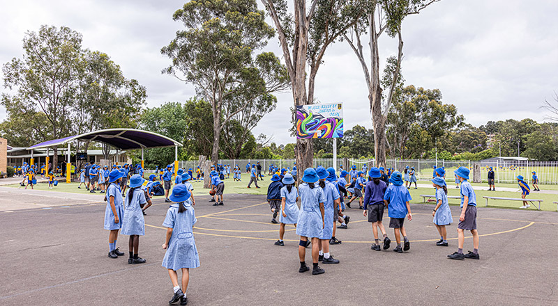 Students playing on the basketball court at St Andrews Primary School Marayong