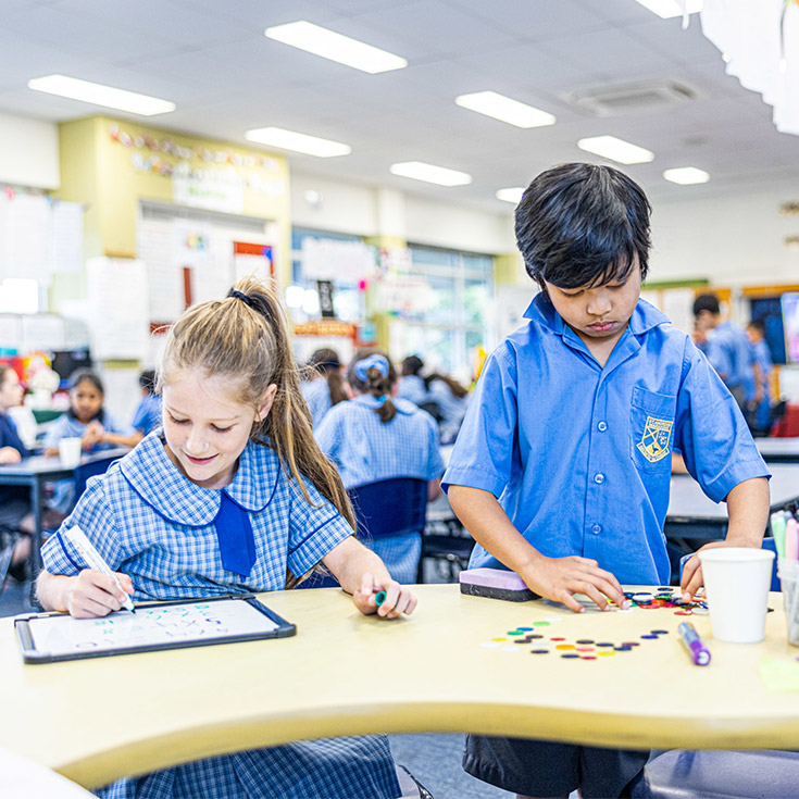 Students working together in the classroom at St Andrews Primary School Marayong